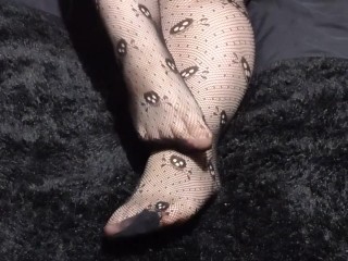 Close up of Wolf's cute feet in skull fishnets for your foot fetish pleasure