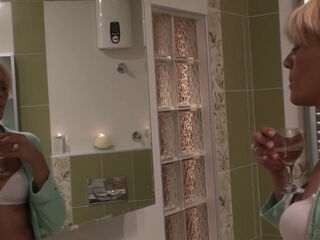 A slender, mature woman named Karine C. engages in self-pleasure while bathing.