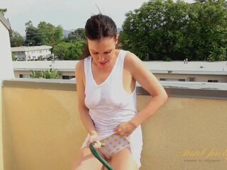Naughty Nancy Vee refreshes her shaved MILF pussy with a garden hose