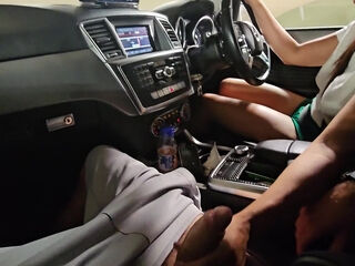 While our car is immobilized in freeway congestion, she grasps my penis in her hand.